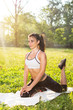 © Bojan - Yoga outdoors. Young healthy beautiful woman is doing a yoga in the green park.
