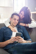 © Bojan - Young couple looking at smartphone together at home.