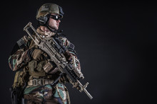 United States Marine Corps Special Operations Command Marsoc Raider With Weapon. Studio Shot Of Marine Special Operator Half-turning Black Background