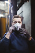 © hedgehog94 - Worker with protective mask in factory for production heavy pellet stoves and boilers.