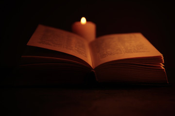 Wall Mural - Bible and burning candle on table