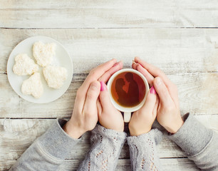 lovers holding together a Cup of tea. Selective focus.  