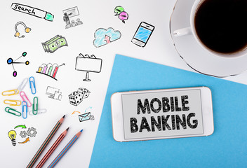 Wall Mural - Mobile banking. Mobile phone and coffee cup on a white office desk.