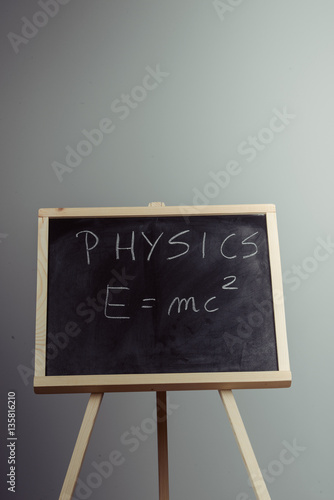 Physics word and formula E=mc2 on chalkboard Poster