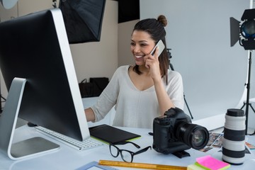 Female photographer talking on mobile phone