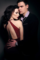 fashion studio photo of lovely impassioned couple in elegant out