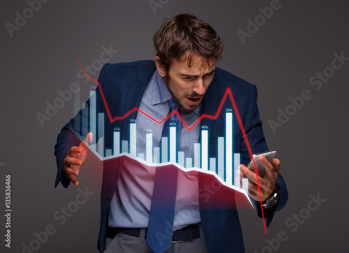 Fotografía Businessman with chart in the fall, economy going down.