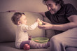 © scaliger - Cute baby girl plays with fruits with her father