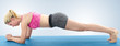 © Lovrencg - Young woman doing full body yoga exercise  on blue mat