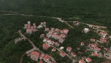 Camera Flying To Adriatic Highway (Jadranski Put) Passing Near Petrovac Town. Aerial View On The Route On Mountain. Montenegro
