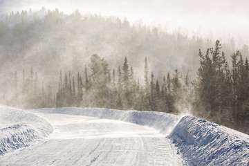 Snowy winter road during blizzard in Russia. Heavy snow storm.