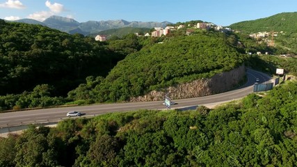 Wall Mural - Cars driving two-lane road around hill. Adriatic highway, Montenegrin section near Jaz beach. Montenegro
