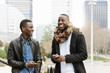 © santypan - Business men using mobile in the Street.