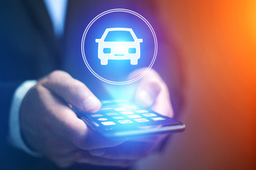 Wall Mural - businessman hand holding mobile phone with car icon