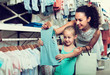 young woman and girl in clothes store.