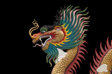 Colorful dragon statue isolated on black background