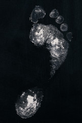 White footprint isolated on black background.Top view.Closeup.