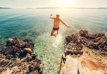 Man Jumps In Blue Sea Lagune Water