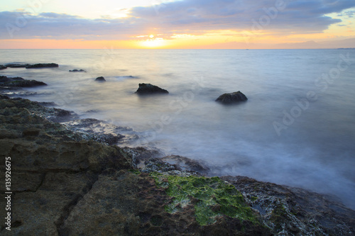 Sea coast in a long exposure shot, with blurred water Poster