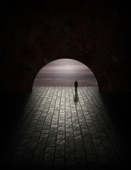 Man in tunnel with gloomy ocean view