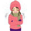 Young woman freezing wearing winter clothes shivering