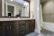 © Iriana Shiyan - White and brown bathroom boasts a nook filled with double vanity