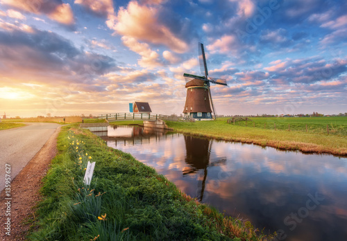 Windmill near the water canal at sunrise in Netherlands Canvas