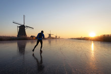 Ice Skating At Sunrise In The Netherlands