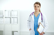 © lenets_tan - Woman doctor standing with folder at hospital