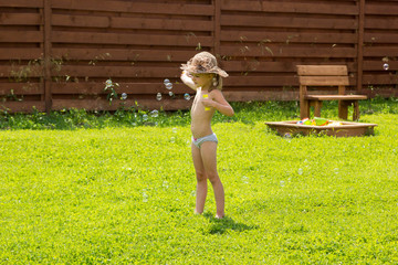 little girl playing with soap bubbles