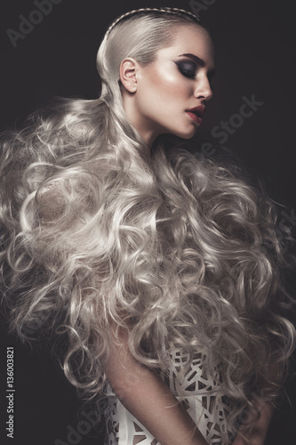 Naklejka na szybę Beautiful girl in art dress with avant-garde hairstyles. Beauty the face. Photos shot in the studio.