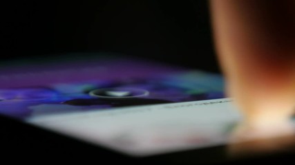 Wall Mural - man scrolls news feed on the smartphone screen, macro 