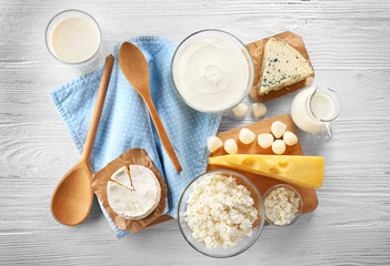 Wall Mural - Different types of dairy products on wooden background