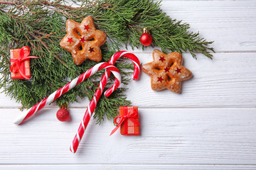 Wall Mural - Christmas decorations and candies on white wooden background