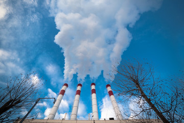 environmental pollution concept, pipes and smog on blue sky background