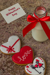 Cookies for Valentine's day and glass bottle of milk with red ri