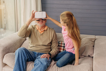 Wall Mural - Happy grandparent watching vr headset