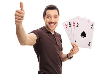 Poster - Joyful guy making a thumb up sign and holding four aces