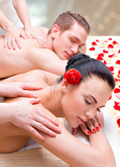 Wall Mural - Couple lying  in a spa salon enjoying back massage.