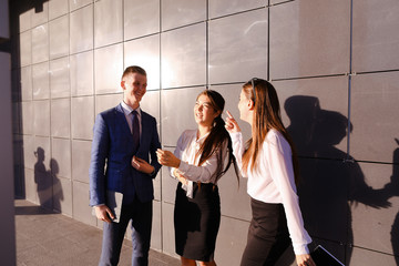 three young attractive educated young businessman talking, smili