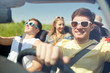 © Syda Productions - happy friends driving in cabriolet car