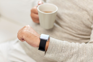 Poster - close up of senior man with tea and wristwatch