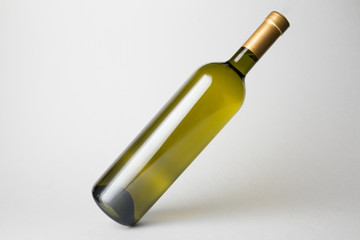 Slanted bottle on gray background