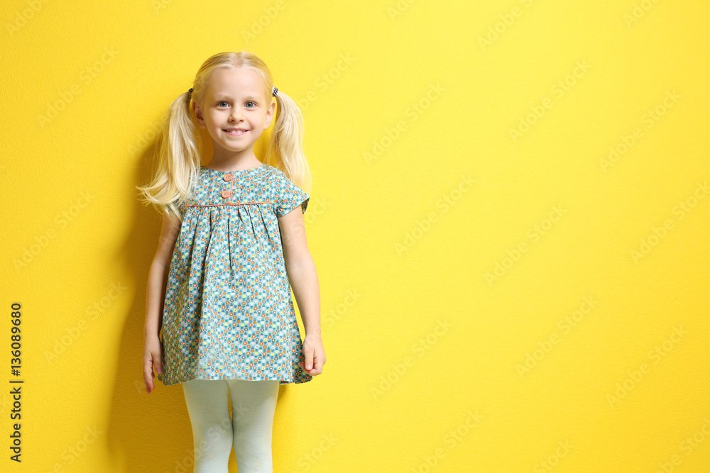 Cute little girl on color background
