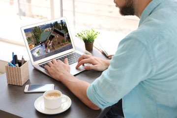 Online shopping concept. Man looking for house on real estate market website