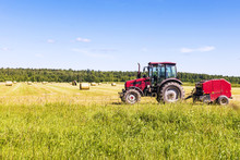 Red Tractor In The Field On A Hay