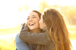 © Antonioguillem - Two happy friends hugging and kissing