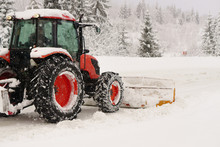 Red Snowblower Grader Clears Snow Covered Ski Resort Road In Mountains Or City Street. Winter Snowflake Snowfall Weather. Horizontal, Copy Space.