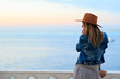 © yanamavlyutova - Beautiful woman in cowboy wild west style, cowboy hat and jeans jacket, fashion portrait photosession, advertising, sea view landscape, blue sky sunset