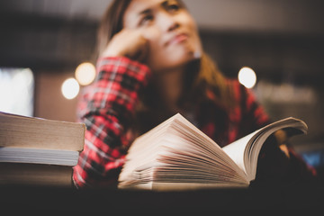 Wall Mural - Hipster woman teenager sitting enjoy reading book at cafe. 